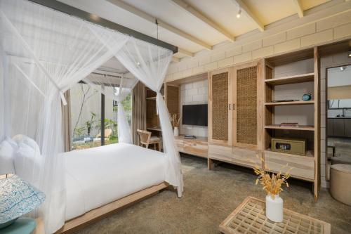 a bedroom with a bed with a mosquito net at Chaparrals Surf in Dickwella