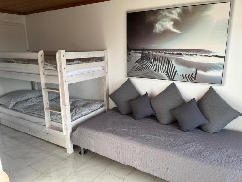 a bedroom with two bunk beds and a couch at Swiss Alps in Brenzikofen