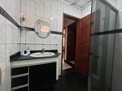 a bathroom with a sink and a mirror at Casa Gabo in Serra