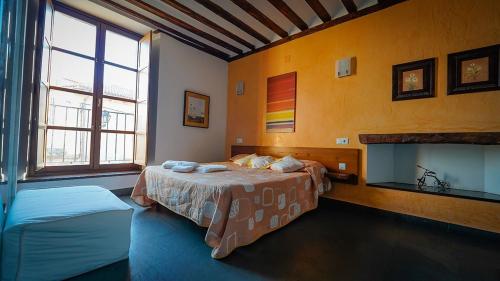 a bedroom with two beds and a fireplace at Antiguo Palacio De Atienza in Atienza