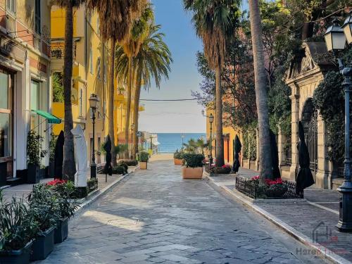 a street in a city with palm trees and the ocean at Mare & Comfort - Box Auto - Balcone - Free Wifi in Borghetto Santo Spirito
