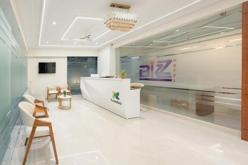 a lobby with a reception desk and chairs at Treebo Premium Bizz in Ahmedabad