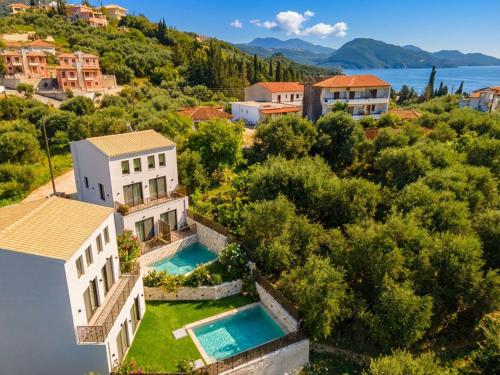 an aerial view of a house with two swimming pools at Malou and Charma Villas in Syvota