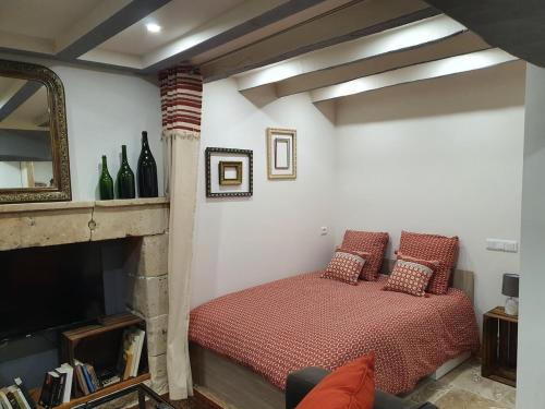 a bedroom with a bed and a fireplace at Maisonette, Gîte de la Mère Nini in Saint-Laon