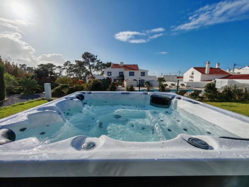 a hot tub in the backyard of a house at Quinta do Canal in Vila Nova de Milfontes