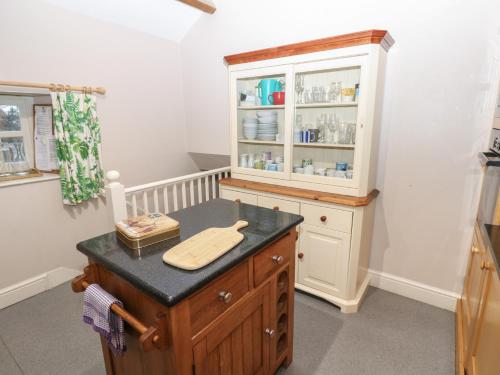 a kitchen with a counter with a hutch at The Tithe Barn in Barnard Castle