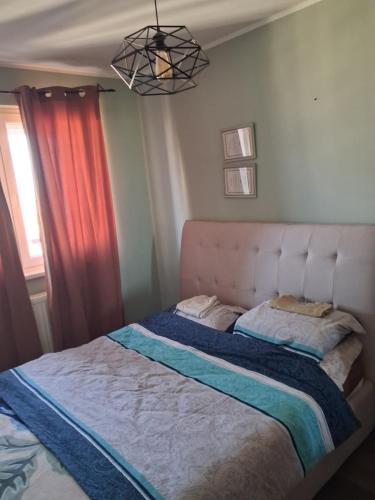 a bedroom with a large bed with two pillows at Stan na dan Mara in Bijeljina
