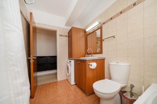 a bathroom with a toilet and a sink at 2 bedroom flat in Strovolos