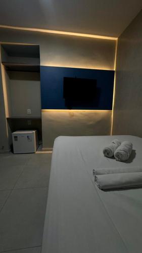 a bedroom with a bed with two towels on it at Pousada Meireles in Fortaleza