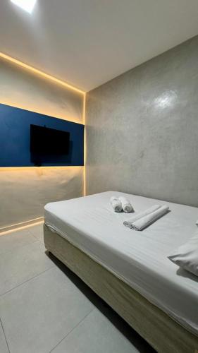 a bedroom with a bed with two towels on it at Pousada Meireles in Fortaleza