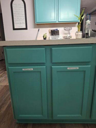 a kitchen counter with green cabinets and a counter top at A&D Homes Peaceful Retreat in Jacksonville