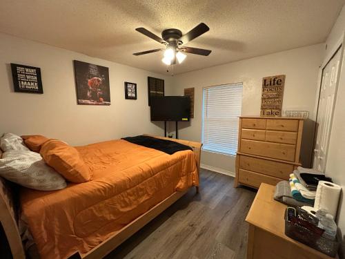 a bedroom with a bed and a ceiling fan at A&D Homes Peaceful Retreat in Jacksonville