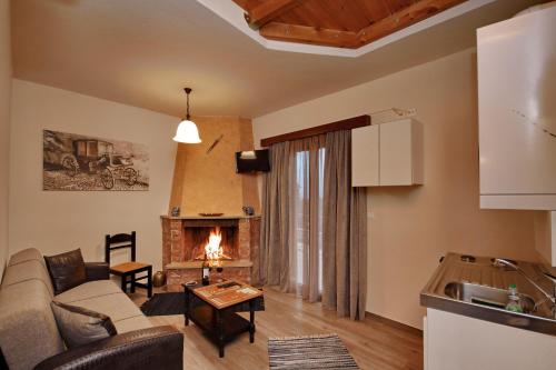 a living room with a couch and a fireplace at Valtessiniko Studios in Valtessiniko