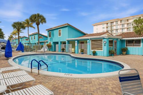 a swimming pool in front of a building at Sand Dune Shores in Palm Beach Shores