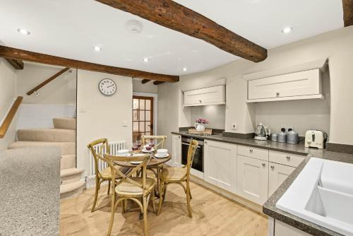 a kitchen and dining room with a table and chairs at WhiskAwayHomes - Hester'sHouse - Luxury Cottage in Broadway