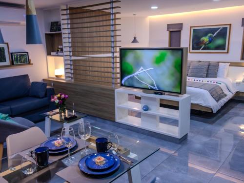a living room with a television and a bed at The Lu'um House in Tuxtla Gutiérrez