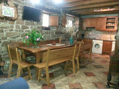 a kitchen with a wooden table with chairs and a microwave at Casa Miguel in Olea