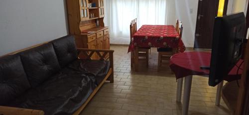 a living room with a couch and a table at Duplex 137 Gesell in Villa Gesell