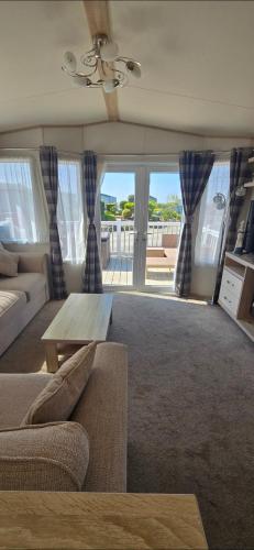 a living room with a couch and a table at Joy & Mick's Happy Place in Morecambe