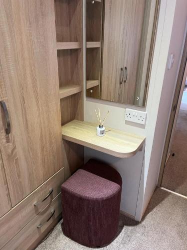 a dressing table with a stool and a mirror at Joy & Mick's Happy Place in Morecambe