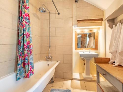 a bathroom with a tub and a sink at 4 Bed in Buxton oc-57687 in Millers Dale