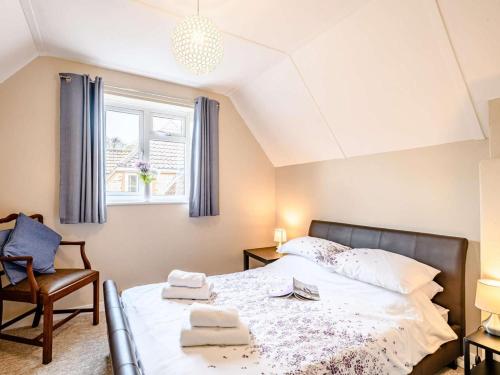 a bedroom with a bed and a chair and a window at 2 Bed in Holt oc-73518 in Holt