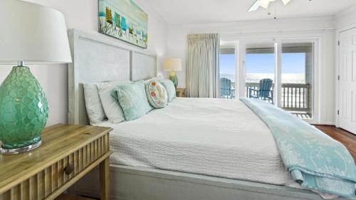 a bedroom with a bed and a table with a vase on it at Blue Nine 2 in Panama City Beach
