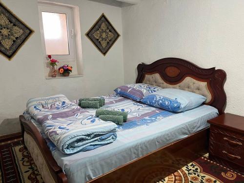 a bed with pillows on it in a bedroom at Hotel Zukhritdin in Bukhara