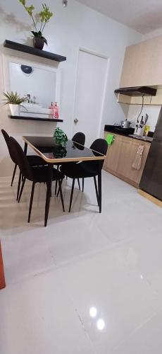 a dining room table and chairs in a kitchen at Rye Lees Place in Bacolod