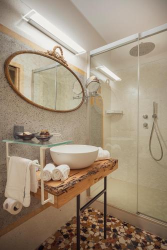 a bathroom with a sink and a mirror and a shower at Cinqueteste Luxury Home in Venice
