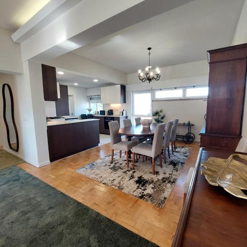 a dining room and kitchen with a table and chairs at OLIVA 50 - 4 Bedrooms and Office - 3 Bathrooms - Near Lisbon Expo & Airport in Lisbon