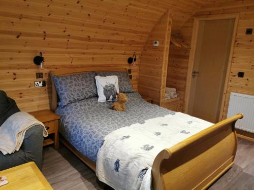 a bedroom with a bed with a teddy bear on it at Lodge 3 in Llanelli