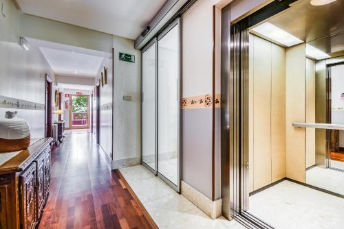 a hallway with sliding glass doors in a house at Hotel Leku Eder in San Sebastián