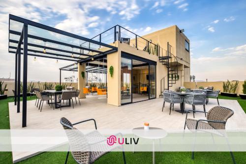 a rendering of a house with a deck with chairs and tables at ULIV Apartments Polanco in Mexico City