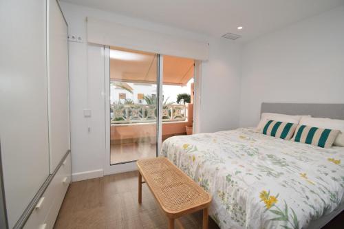 a bedroom with a bed and a chair and a window at Barocco Villa private pool in Santa Pola