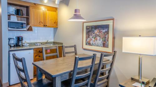 a kitchen with a wooden table and chairs in a kitchen at Cahilty #231 home in Sun Peaks