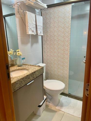 a bathroom with a toilet and a sink and a shower at Manaíra Apart Hotel - Flat 201 in João Pessoa
