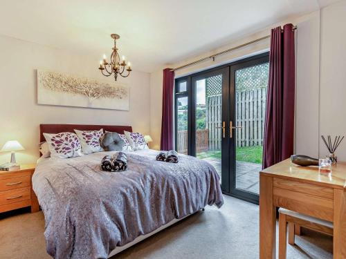 a bedroom with a bed and a large window at 3 Bed in Swanage oc-94067 in Swanage