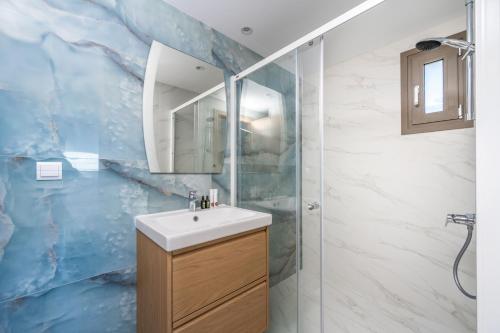 a bathroom with a sink and a shower at Astarte Villas - Casa De Sun Private Villa with Pool in Zakynthos