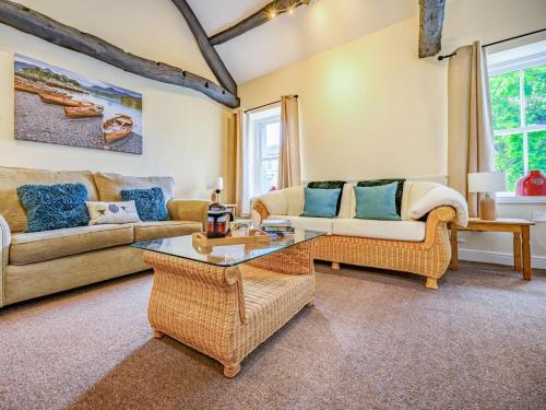 a living room with two couches and a table at 1 Bed in Cockermouth oc-87480 in Cockermouth