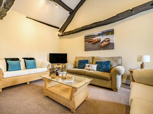 a living room with two couches and a coffee table at 1 Bed in Cockermouth oc-87480 in Cockermouth