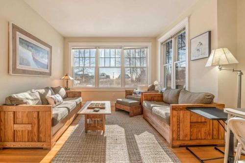 a living room with a couch and a table at Town & Tide Home for 8 in Kennebunkport