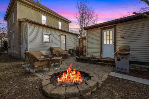 a fire pit in a yard next to a house at Broadway Cottage - Town, Hot Tub, Fire Pit, Grill, Wifi, Family Friendly, Pet Friendly in Berkeley Springs
