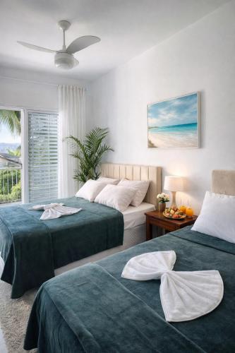 a bedroom with two beds and a window at LAAR Hotel in Praia Grande