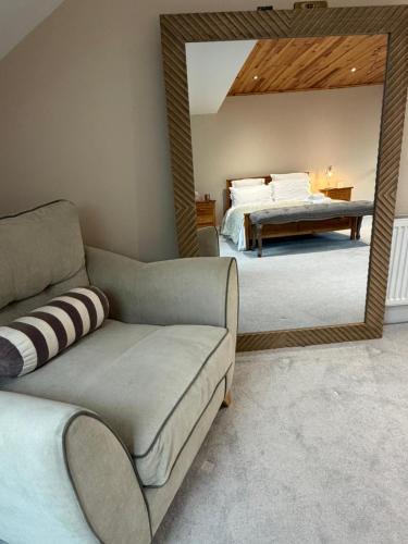 a living room with a couch and a mirror at Sessaigh lake studio in Dunfanaghy