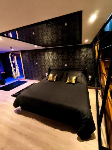 a bedroom with a large black bed in a room at Loveroom LovaLova in Reims