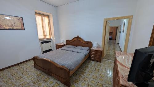 a bedroom with a bed and a flat screen tv at La Mola B&B in Vignanello