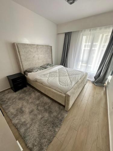 a bedroom with a bed and a rug at BlaQ Homes in Kanga
