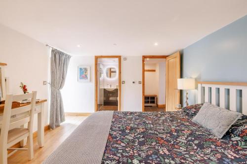 a bedroom with a bed and a desk in it at 2 Bed in Lixwm oc-bow179 in Halkyn