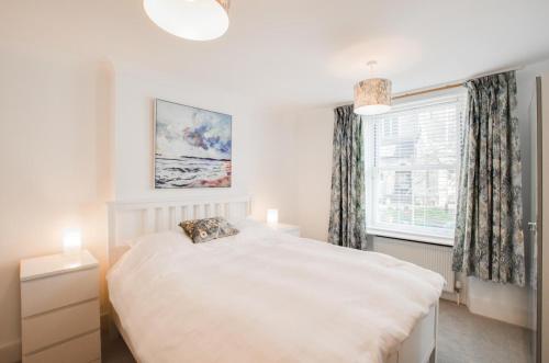 a bedroom with a white bed and a window at 3 Bed in Beer oc-jbvalh in Beer